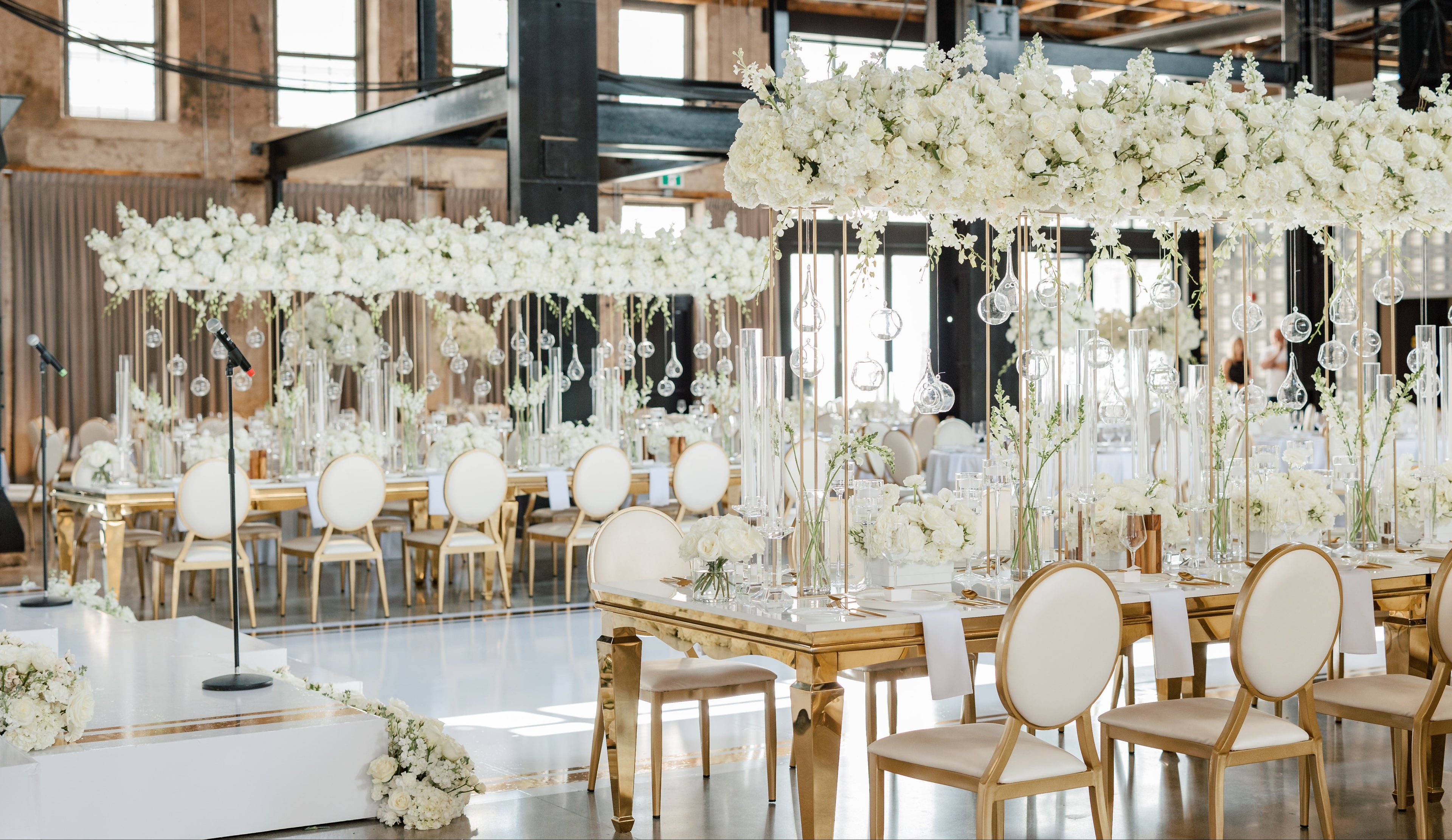 Decorative indoor setting with floral arrangements and tables.